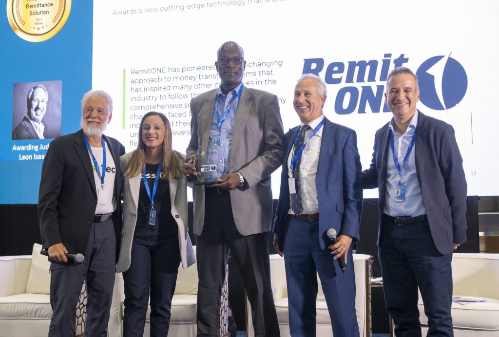Image of Remitone member proudly posing with panel judges after winning a prestigious award